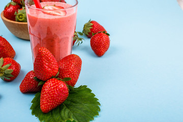 fresh strawberrysmoothie or milkshake on a delicately blue background