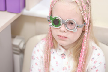 Eyesight check. Caucasian girl who have vision disabilities.Medical treatment and Rehabilitation