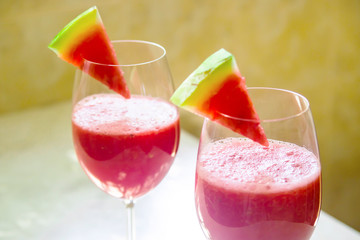 Watermelon cocktail in a glass with a slice of watermelon for decoration. Summer fruit cooling healthy drink