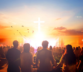 Worship concept:Silhouette people looking for the cross on  sunrise background