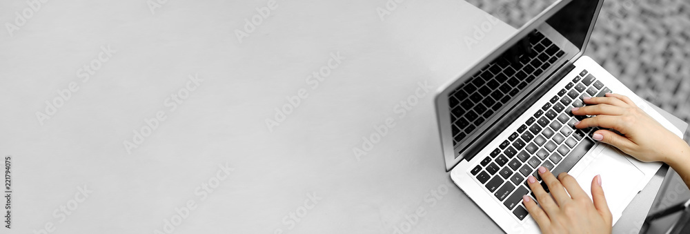Wall mural website banner of laptop with female typing hands, copy space in grey color. concept of blog header 