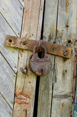 Old lock on the door. lock on the door of an old farmhouse . true village style
