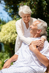 Senior woman visiting husband in hospital