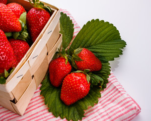 Juicy fresh strawberries in a wooden basket