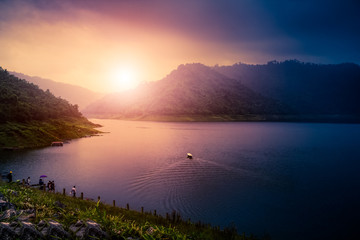 Out of focus of :  green mountain and Water in the dam between the hills with Boat Sailing On Lake for Nature Tours boat ride, The Khun Dan Prakan Chon Dam, Nakhon Nayok Province, 