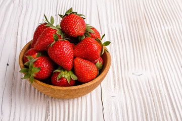Juicy fresh strawberry on a rustic wooden background