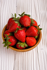 Juicy fresh strawberry on a rustic wooden background