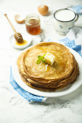 Homemade crepes with honey and butter
