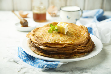 Homemade crepes with honey and butter