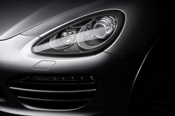 Fototapeta na wymiar Car detailing series: Clean headlights of gray SUV