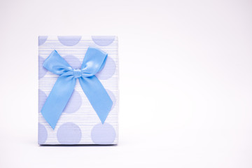 Handmade blue beautiful gift box with blue ribbon on white isolated background