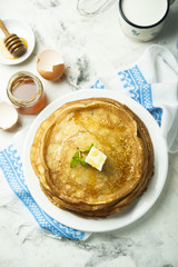 Homemade crepes with honey and butter