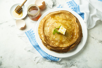 Homemade crepes with honey and butter