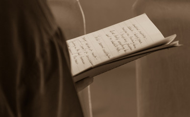 Naklejka premium Woman reading handwritten notes at Dalai Lama talk