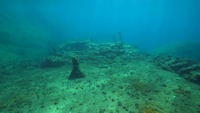 Underwater moving above a shipwreck on the seabed in the Mediterranean sea ( 1968, the ship Melchuca carried a load of cement ), Catalonia, Costa Brava, Spain
