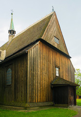 Fototapeta na wymiar The historic St Bartholomew's Parish Church in Nowa Huta, Krakow. This wooden gothic church has a three nave body and dates from 1466 