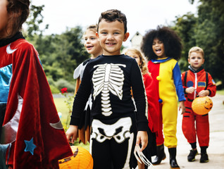 Fototapeta premium Young kids trick or treating during Halloween