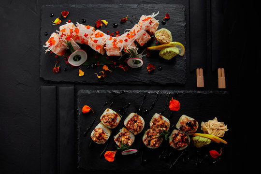 top view of roll in mamenori with shrimp, salmon and avocado in sauce nigiri and roll with creamy eel and kimchi mayonnaise