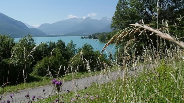 view of Lake Annecy with bike path slow motion
