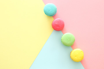 Multicolored macaroons on pastel geometric background