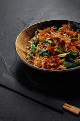 close-up view of delicious asian dish on plate and chopsticks