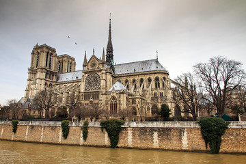 Fototapeta na wymiar Side view of the Notre-Dame Cathedral in Paris with a moody sky