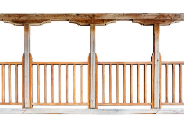 A wooden railing of a balcony with wooden columns isolated on white background