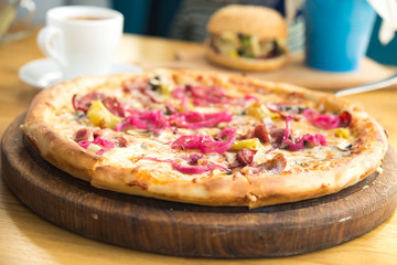 tasty italian pizza with cheese, pickled onion, mushrooms and salami