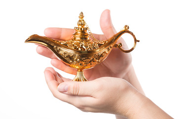 Rubbing magic lamp with female hands isolated on white background. Concept for wishing, luck and...