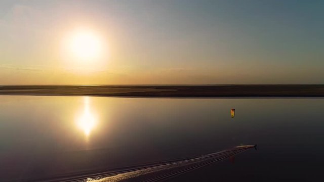 Aerial shooting, kitesurfer on the lake at dawn