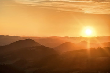 Beautfull sunset view around mountains. Sunlight on the sky with