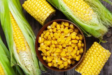 Ripe corn on a wooden table.