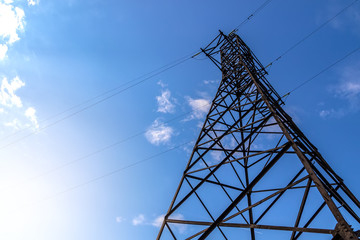 Power line support against blue sky background