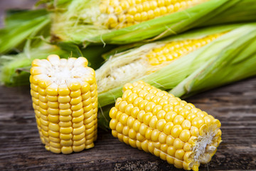 Ripe corn on a wooden table.