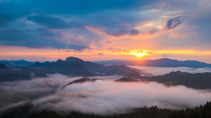 wonderful, beautiful sunset in the mountains. The fogs were illuminated by the setting sun