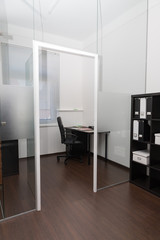 Modern space office with furniture. Office space interior. Glass door with metal handles