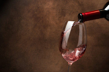 Red wine pouring in wineglass
