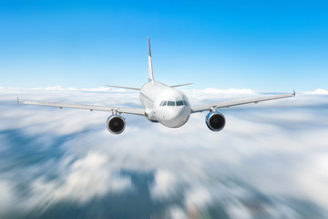 Airplane in the sky above the clouds flight journey sun height speed motion blur.