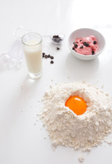 preparation of a cake with strawberry ice cream on wooden white background