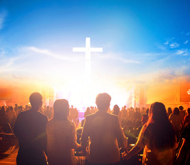 Worship concept:Silhouette people looking for the cross on  sunrise background