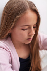 Sad teenager girl with downcast eyes - closeup portrait