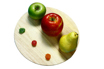Still life of three different fruits on a round board.