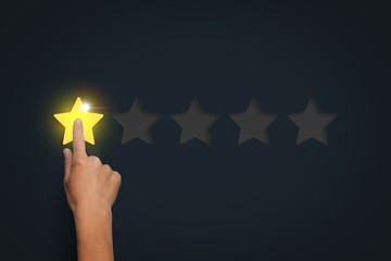 Female hand leaves a rating of one star out of five possible aga