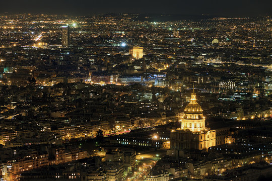 Fototapeta Beautiful aerial cityscape of Paris, France, at night with the Dome des Invalides and the Arc de Triomph