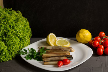Fresh seafood with parsley and lemon, salad and tomatoes, italian cuisine, grey backgraund and copyspace