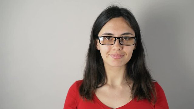 girl with glasses isolated on grey wall background.