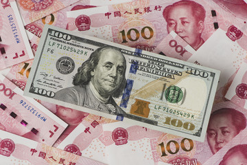 US dollar bill and Chinese yuan banknote. USD vs RMB.