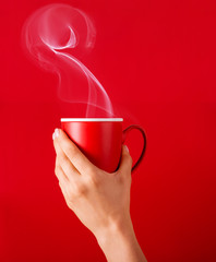 Woman with a cup of fragrant coffee in her hands on a cool day. Black warm coffee in cold...