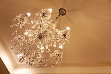 Obraz premium Chrystal chandelier lamp on the ceiling in Dining room Adjusting the image in a Luxury tone .Decorative elegant vintage and Contemporary interior Concept.