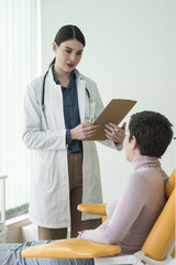 A Woman Physician Talking With Her Patient